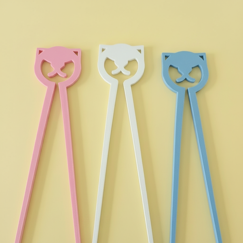 Close-up of the three pastel cat chopsticks